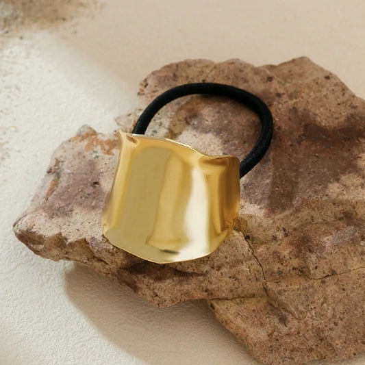 A Solid Gold Curved Hair Tie